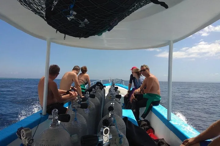 A group of people on a dive boat preparing for a scuba dive.